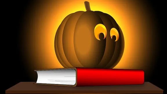 Illustration of a Halloween pumpking on a book