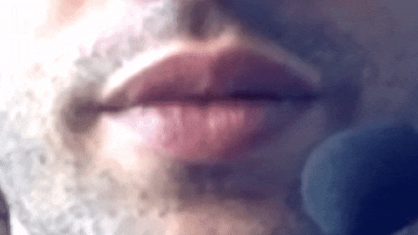 GIF showing a zoomed in human mouth speaking through a headset microphone