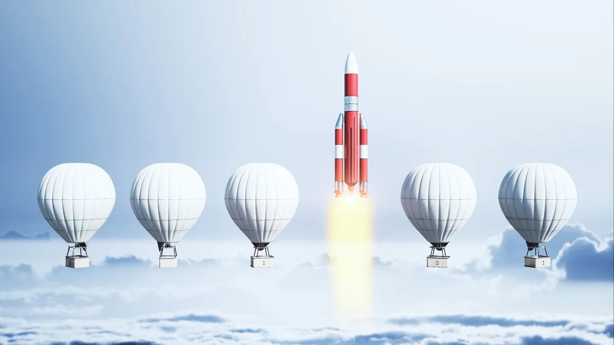 Hot air balloons and rocket departing