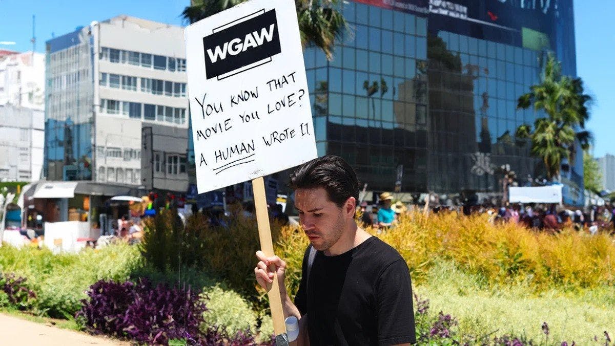 WGA strike participant holding a picket sign