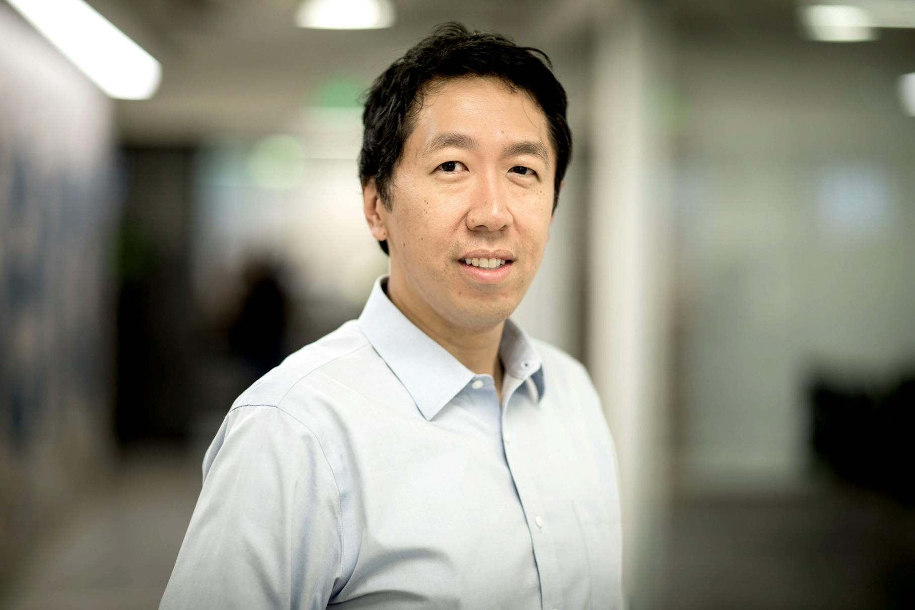 Andrew Ng, CEO of DeepLearning.AI, stands in his company's office.