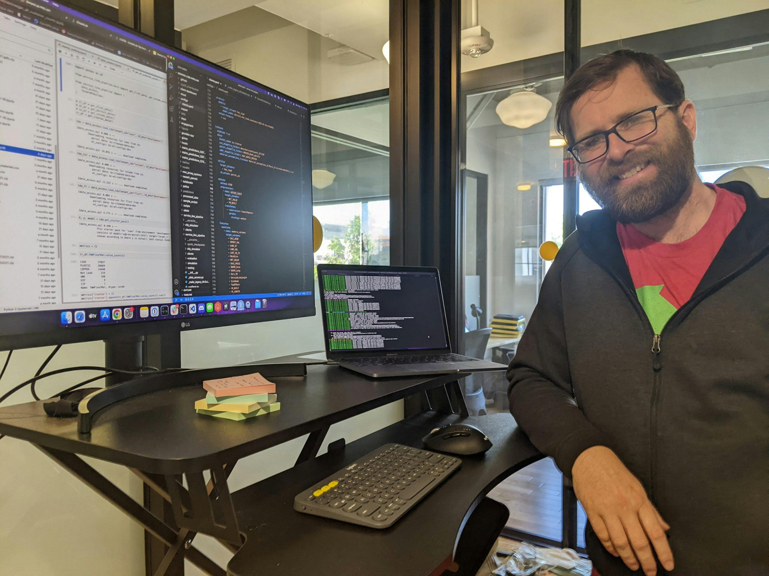 BlueConduit's head of data science, Jared Webb, poses next to his work station.